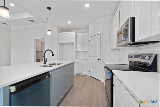 2002 Rosson St, Nolanville, TX 76559 - kitchen featuring stainless steel appliances, white cabinets, light wood-style floors, and recessed lighting