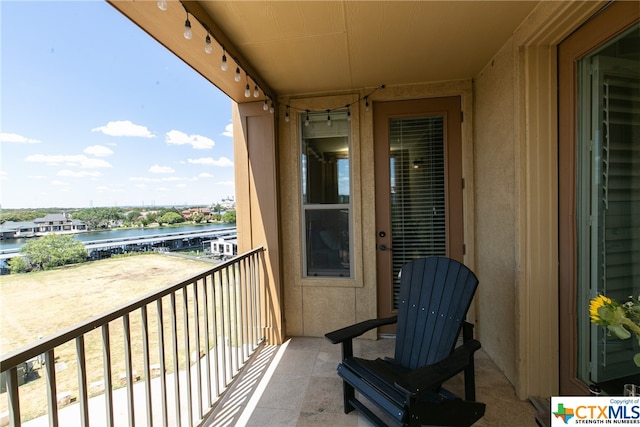 balcony featuring a water view