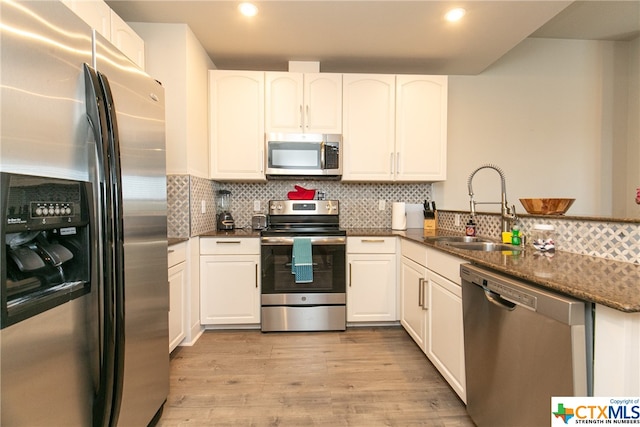 kitchen featuring light hardwood / wood-style flooring, white cabinetry, sink, and stainless steel appliances