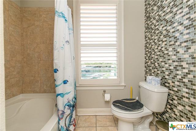 bathroom featuring toilet, tile patterned floors, and shower / tub combo