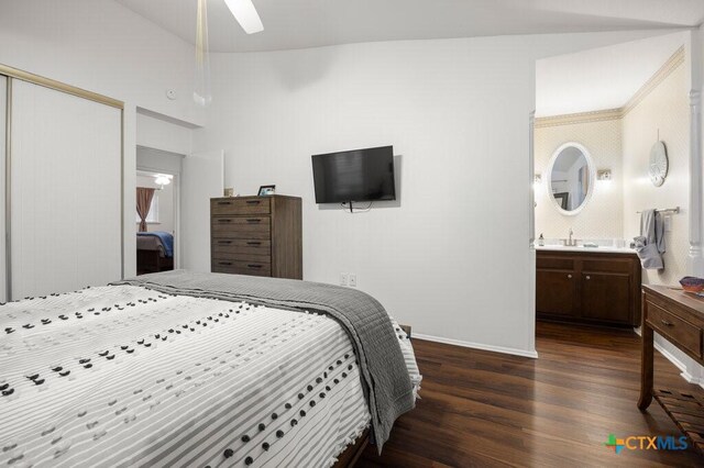 5006 Las Campanas St, San Antonio, TX 78233 - bedroom with dark wood-type flooring, a closet, a sink, baseboards, and ensuite bathroom