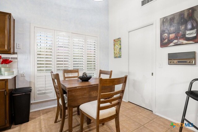 5006 Las Campanas St, San Antonio, TX 78233 - dining room featuring light tile patterned floors, a towering ceiling, and baseboards
