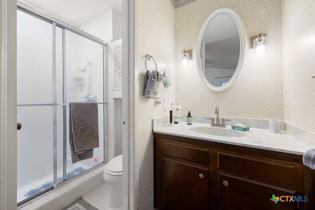 5006 Las Campanas St, San Antonio, TX 78233 - bathroom featuring wallpapered walls, vanity, toilet, a shower stall, and tile patterned floors