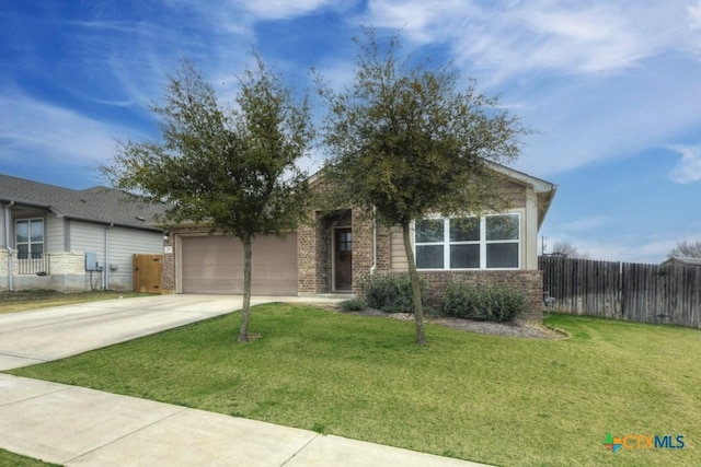 view of front of house featuring brick siding, an attached garage, fence, driveway, and a front lawn