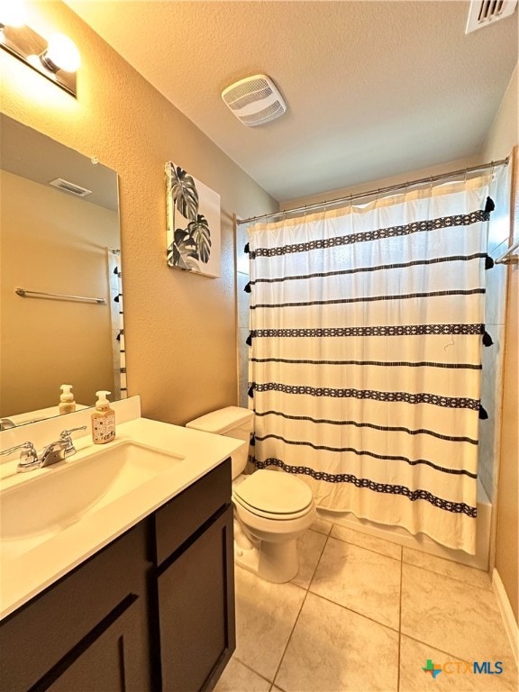 full bathroom featuring tile patterned floors, toilet, a textured ceiling, vanity, and shower / tub combo with curtain