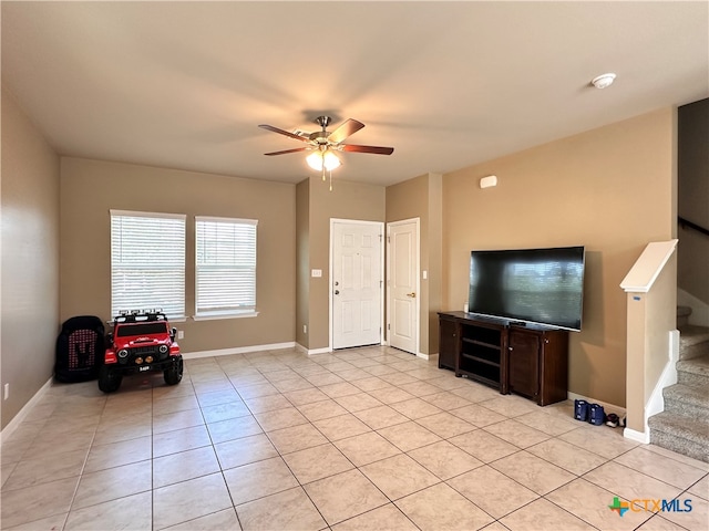 tiled living room with ceiling fan