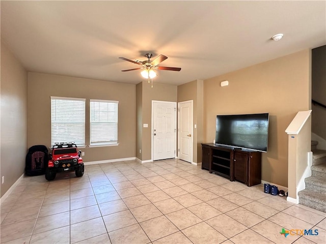 125 Duck Creek Trl, San Marcos, TX 78666 - living room featuring stairs, a ceiling fan, light tile patterned floors, and baseboards