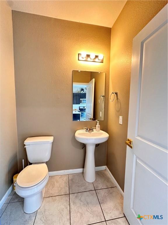 125 Duck Creek Trl, San Marcos, TX 78666 - bathroom featuring toilet, tile patterned floors, and a textured wall
