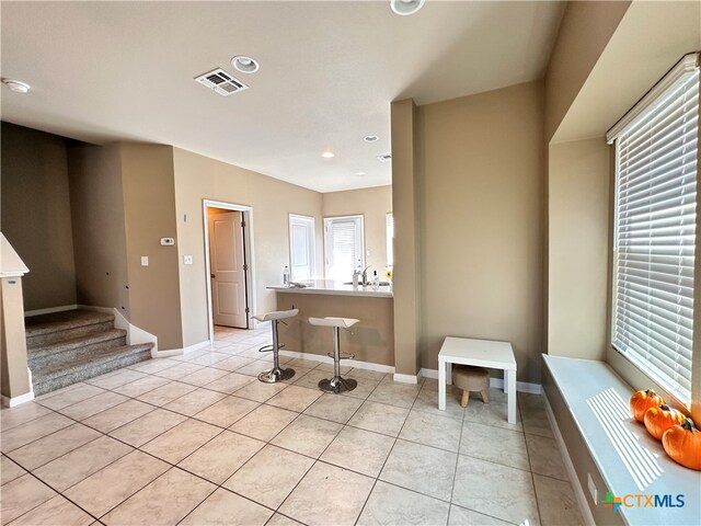 interior space featuring tile patterned floors and plenty of natural light