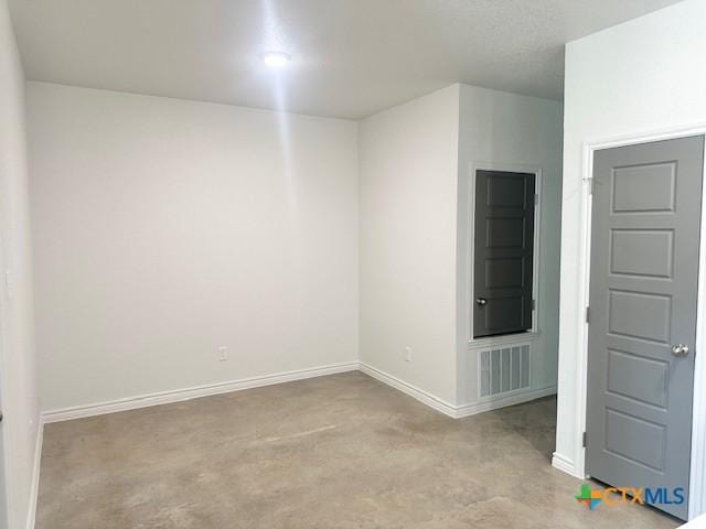 2310 Ocean Ave, Temple, TX 76501 - empty room with concrete floors, visible vents, and baseboards