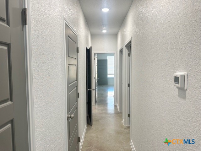 2310 Ocean Ave, Temple, TX 76501 - corridor with a textured wall and finished concrete floors