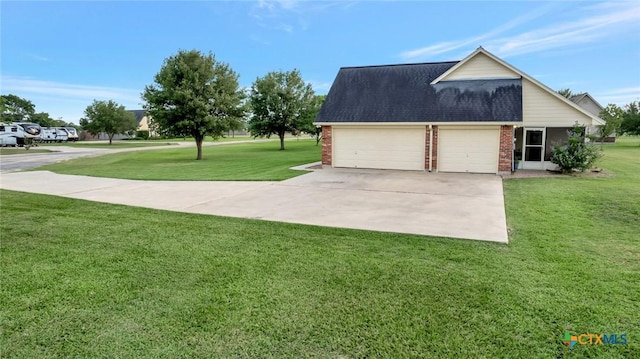 46 Bluestem St, Victoria, TX 77904 - view of home's exterior featuring brick siding, an attached garage, driveway, and a lawn