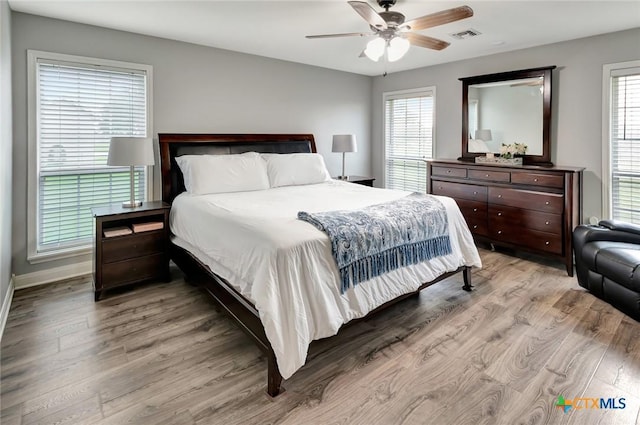 46 Bluestem St, Victoria, TX 77904 - bedroom featuring light wood-style flooring, multiple windows, and a ceiling fan