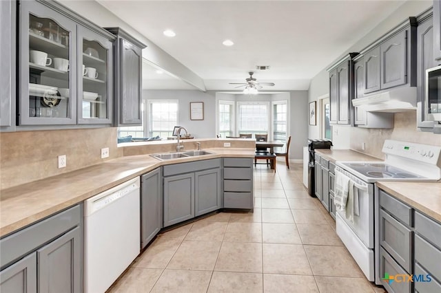 46 Bluestem St, Victoria, TX 77904 - kitchen with white appliances, a sink, under cabinet range hood, gray cabinets, and a peninsula