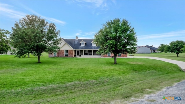 46 Bluestem St, Victoria, TX 77904 - view of front of property featuring brick siding, a front lawn, and a chimney