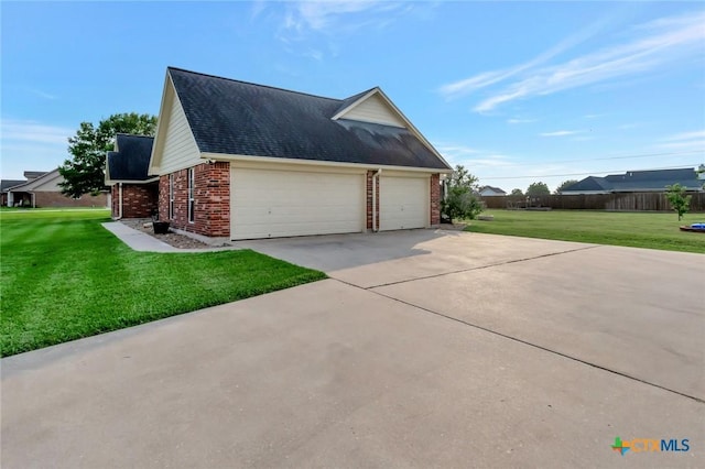46 Bluestem St, Victoria, TX 77904 - view of home's exterior featuring brick siding, a lawn, concrete driveway, and a garage