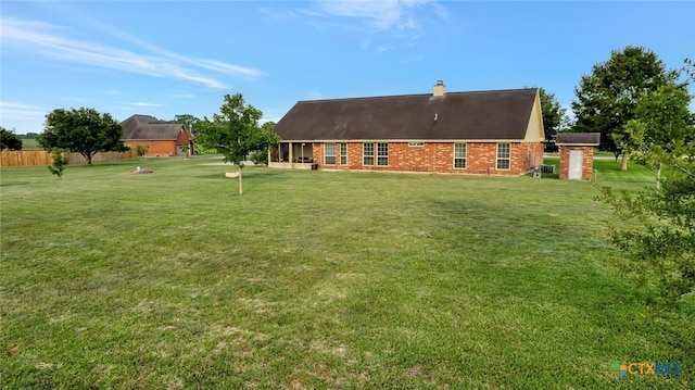 46 Bluestem St, Victoria, TX 77904 - rear view of property featuring a chimney and brick siding