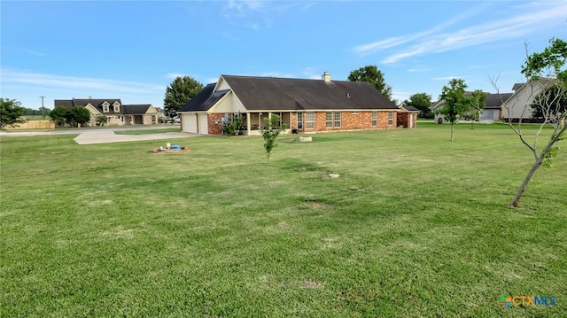 46 Bluestem St, Victoria, TX 77904 - view of grassy yard with driveway and a garage