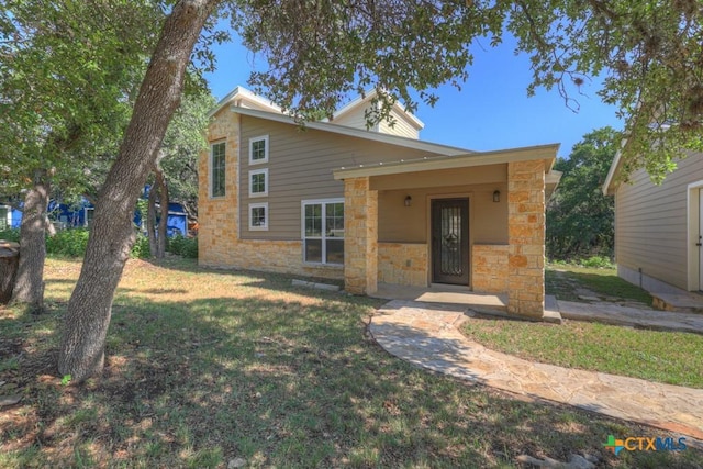 3055 Lakeview Dr, Canyon Lake, TX 78133 - mid-century modern home featuring stone siding and a front lawn