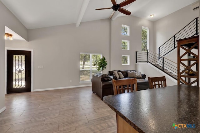 3055 Lakeview Dr, Canyon Lake, TX 78133 - dining room with ceiling fan, beam ceiling, baseboards, stairway, and high vaulted ceiling
