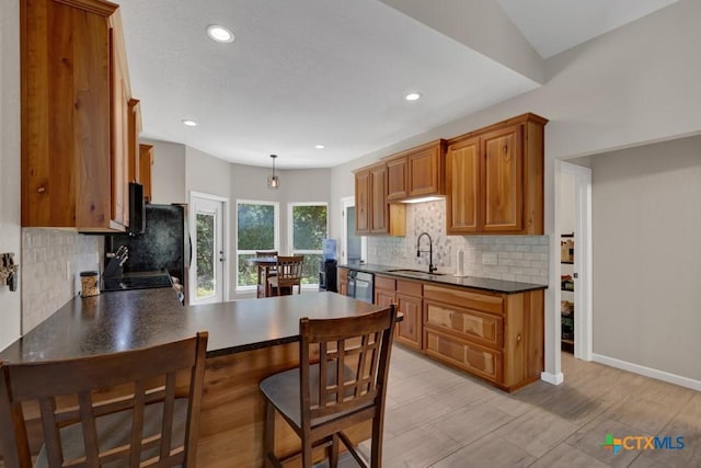 3055 Lakeview Dr, Canyon Lake, TX 78133 - kitchen featuring a sink, dark countertops, dishwashing machine, decorative backsplash, and recessed lighting