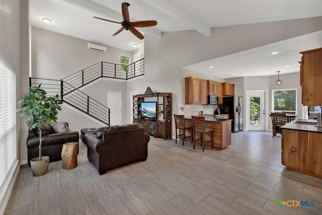 3055 Lakeview Dr, Canyon Lake, TX 78133 - living room featuring a wall mounted air conditioner, ceiling fan, stairway, beam ceiling, and recessed lighting