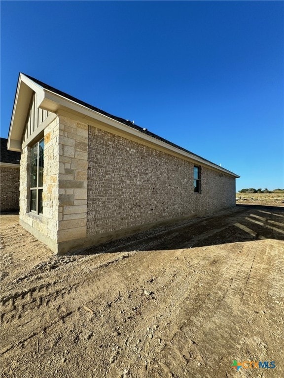 view of side of property featuring stone siding