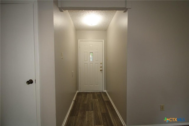 4508 Greenbriar Cir, Killeen, TX 76543 - entryway featuring a textured ceiling, dark wood-style flooring, and baseboards