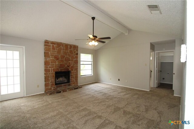 4508 Greenbriar Cir, Killeen, TX 76543 - unfurnished living room with a ceiling fan, carpet flooring, a textured ceiling, a stone fireplace, and baseboards