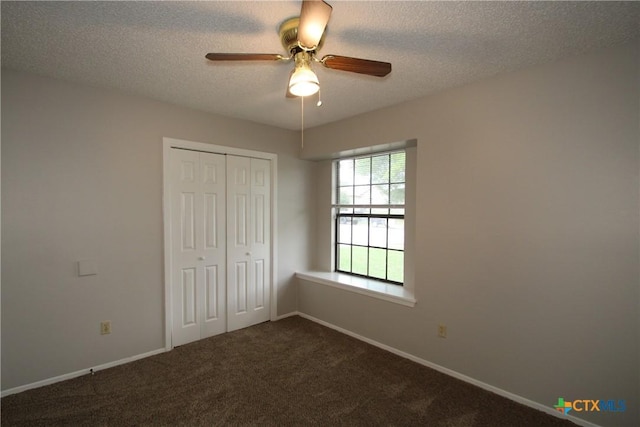 4508 Greenbriar Cir, Killeen, TX 76543 - unfurnished bedroom with a textured ceiling, a closet, dark carpet, baseboards, and a ceiling fan