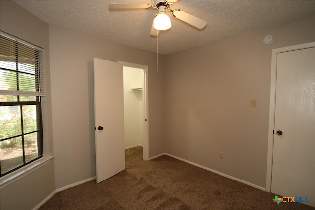 4508 Greenbriar Cir, Killeen, TX 76543 - unfurnished bedroom featuring carpet flooring, a closet, a spacious closet, a textured ceiling, and ceiling fan