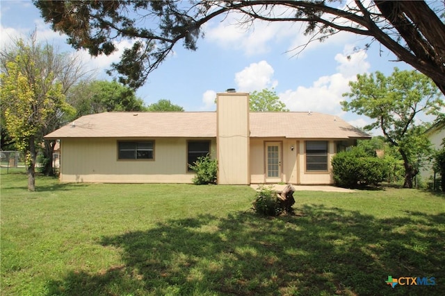 4508 Greenbriar Cir, Killeen, TX 76543 - back of house featuring a chimney and a lawn