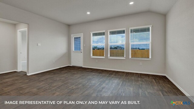 unfurnished room featuring dark wood-type flooring and lofted ceiling