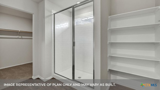 bathroom featuring a shower with shower door