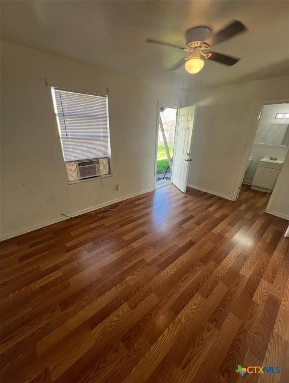 spare room with cooling unit, baseboards, a ceiling fan, and wood finished floors