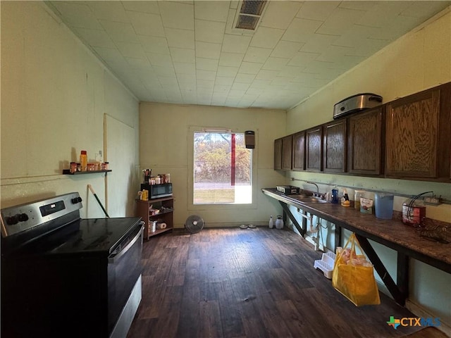 400 Grimes St, Cuero, TX 77954 - kitchen featuring stainless steel electric range, dark wood-style flooring, dark brown cabinetry, and a sink