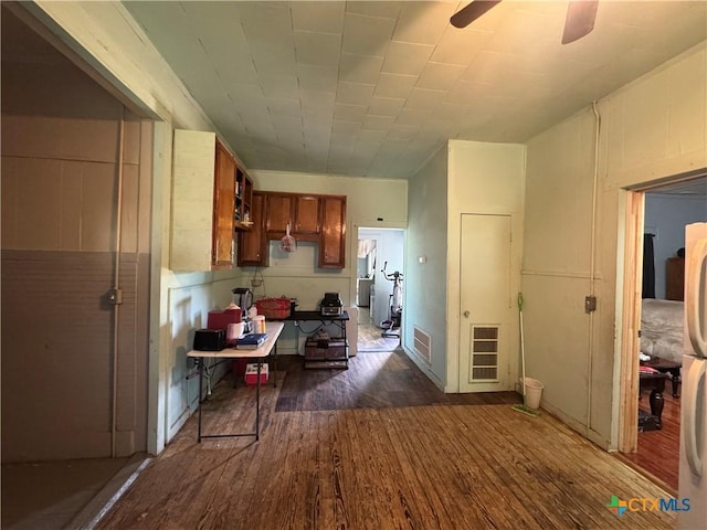 400 Grimes St, Cuero, TX 77954 - kitchen with dark wood-style floors, a ceiling fan, and brown cabinets