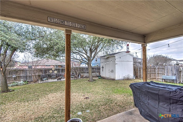 view of yard with a storage shed and a patio area