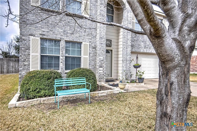 view of front of property featuring a garage and a front lawn