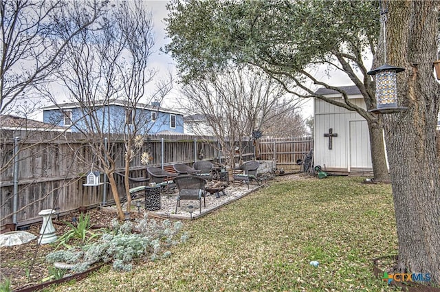 view of yard featuring a storage shed and a fire pit