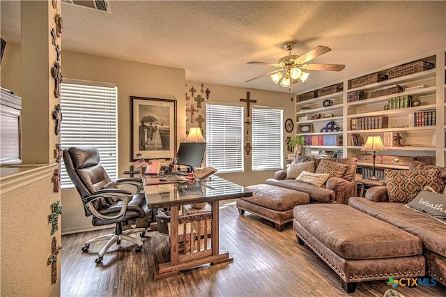 office featuring hardwood / wood-style flooring, a wealth of natural light, a textured ceiling, and ceiling fan