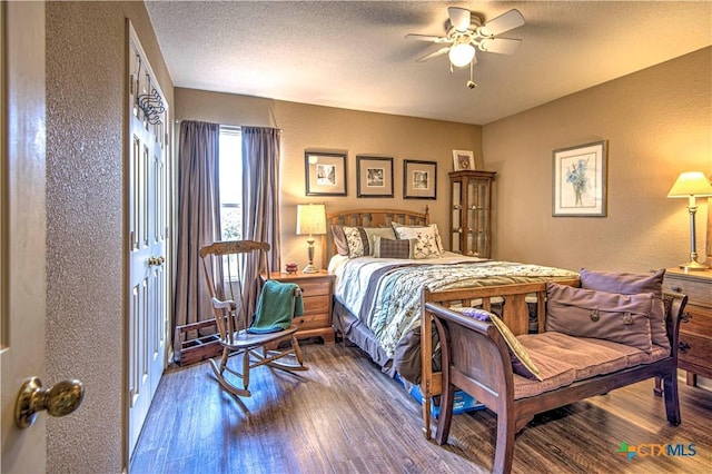 bedroom featuring hardwood / wood-style floors, a textured ceiling, and ceiling fan