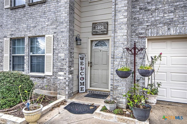 doorway to property featuring a garage