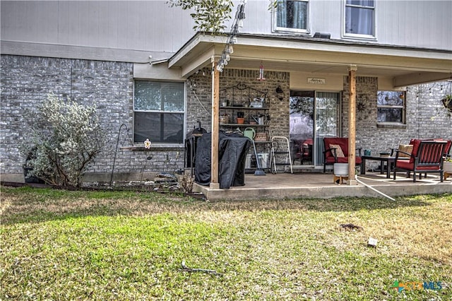 doorway to property with a patio and a yard