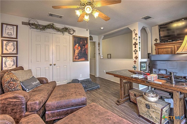 office featuring ceiling fan, dark hardwood / wood-style floors, and a textured ceiling