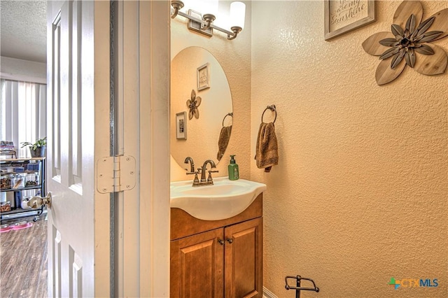 bathroom with vanity and hardwood / wood-style flooring