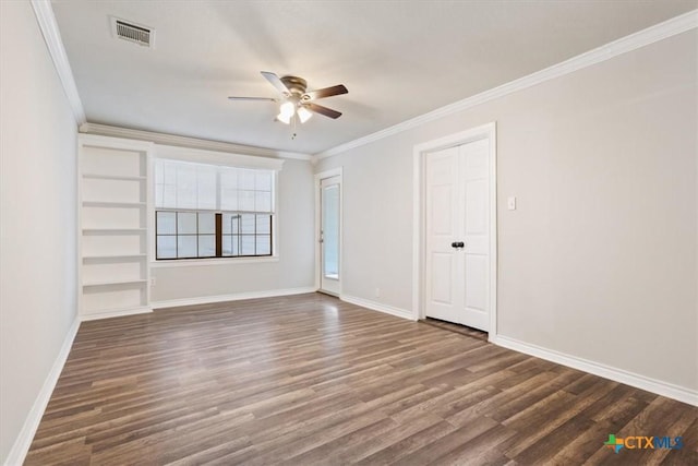 unfurnished room featuring ornamental molding, visible vents, baseboards, and wood finished floors