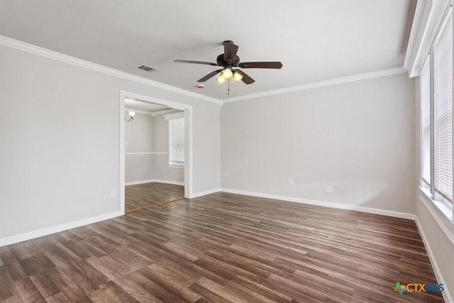 empty room featuring a ceiling fan, baseboards, visible vents, dark wood finished floors, and crown molding