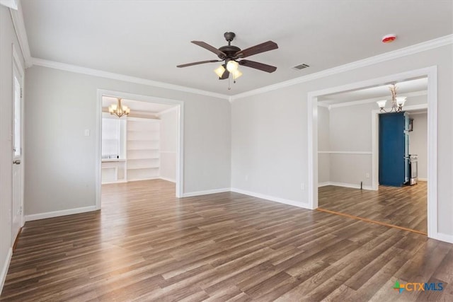 empty room featuring crown molding, visible vents, wood finished floors, baseboards, and ceiling fan with notable chandelier