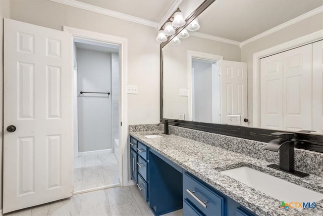 bathroom featuring marble finish floor, crown molding, and a sink